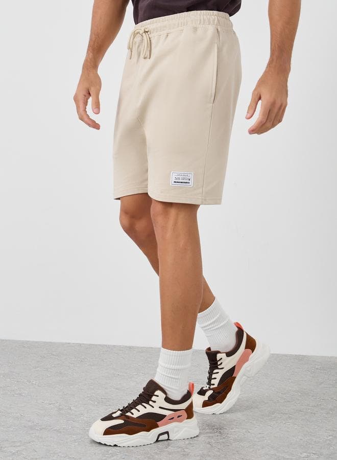 Styli Badge Detail Oversized Terry Shorts Beige - Image 1