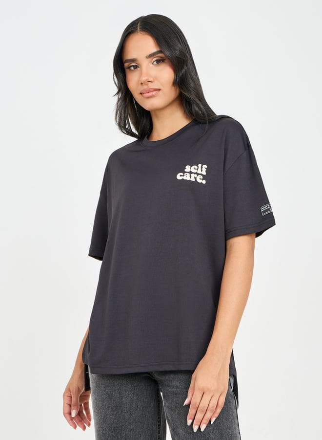 Styli Oversized Slogan High-Low Hem Drop Shoulder Tee - Image 1