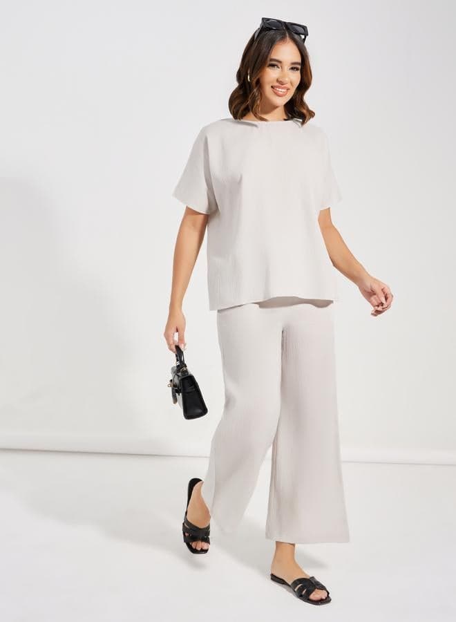 Styli Textured Round Neck Top and Wide Leg Pants Set - Image 1