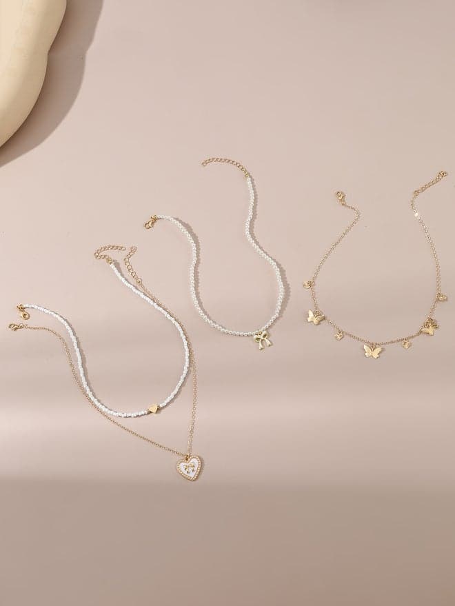 Take Two Set of 4 Bow Pendant Faux Pearl Necklace - Image 1